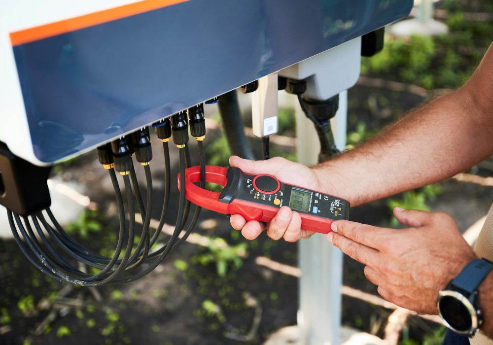 Inspector checking output voltage level of inverter.